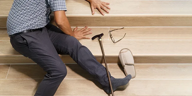 Senior man with stick falling down stair